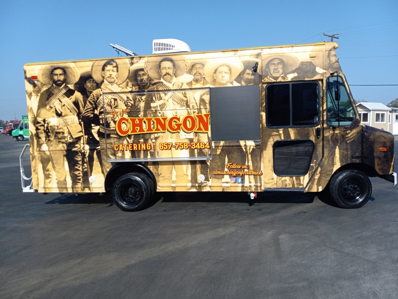 A mustard yellow truck with a design portraying the images of legendary "chingon".